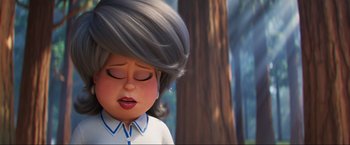 Movie still from “Minions: The Rise of Gru” (2022), directed by Jonathan del Val – A person's face in a forest; Close Up shot, Low angle