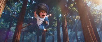 Movie still from “Minions: The Rise of Gru” (2022), directed by Jonathan del Val – An animated character flying through the air in a forest; Wide shot, Low angle
