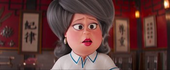 Movie still from “Minions: The Rise of Gru” (2022), directed by Jonathan del Val – An animated woman with a surprised look on her face; Close Up shot, Over the shoulder angle