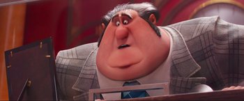 Movie still from “Minions: The Rise of Gru” (2022), directed by Jonathan del Val – An old man with a beard and a tie; Close Up shot, Low angle