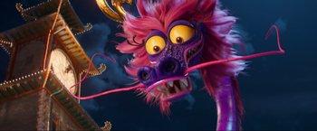 Movie still from “Minions: The Rise of Gru” (2022), directed by Jonathan del Val – A purple and pink dragon mask with yellow eyes; Close Up shot, Low angle