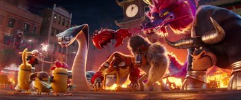 Movie still from “Minions: The Rise of Gru” (2022), directed by Jonathan del Val – A group of animals that are standing in the dirt; Wide shot, Low angle