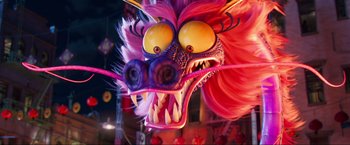 Movie still from “Minions: The Rise of Gru” (2022), directed by Jonathan del Val – A purple dragon mask with yellow eyes and pink hair; Close Up shot, Low angle
