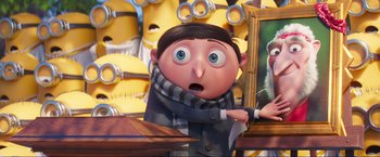 Movie still from “Minions: The Rise of Gru” (2022), directed by Jonathan del Val – An image of a cartoon character with a knife in his mouth; Close Up shot, Over the shoulder angle
