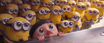 Movie still from “Minions: The Rise of Gru” (2022), directed by Jonathan del Val – A bunch of minions are standing behind a girl; Extreme Wide shot, High angle