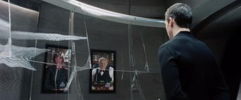 Movie still from “Minority Report” (2002), directed by Steven Spielberg – A man looking at a mirror with a picture of a man in a suit; Medium shot, Over the shoulder angle