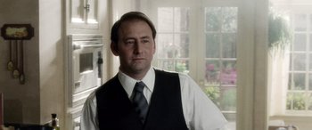 Movie still from “Minority Report” (2002), directed by Steven Spielberg – A man in a vest and tie standing in front of a window; Close Up shot, Over the shoulder angle