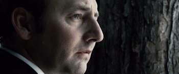 Movie still from “Minority Report” (2002), directed by Steven Spielberg – A man's face with a dark background; Extreme Close Up shot, Low angle