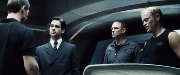 Movie still from “Minority Report” (2002), directed by Steven Spielberg – Two men standing next to each other on a train; Medium shot, Low angle