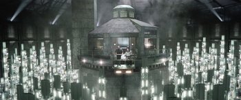 Movie still from “Minority Report” (2002), directed by Steven Spielberg – Two people are standing on a platform in a building; Extreme Wide shot, High angle