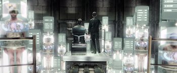 Movie still from “Minority Report” (2002), directed by Steven Spielberg – Two men in suits are standing in front of a building; Wide shot, High angle