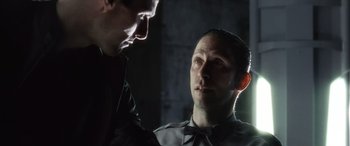 Movie still from “Minority Report” (2002), directed by Steven Spielberg – Two men are looking at each other in the dark; Close Up shot, Over the shoulder angle