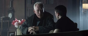 Movie still from “Minority Report” (2002), directed by Steven Spielberg – An older man sitting next to a younger man; Medium shot, Over the shoulder angle