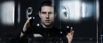 Movie still from “Minority Report” (2002), directed by Steven Spielberg – A person holding a mirror; Close Up shot, Over the shoulder angle