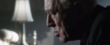 Movie still from “Minority Report” (2002), directed by Steven Spielberg – An older man looking into the distance with his eyes wide open; Close Up shot, Low angle