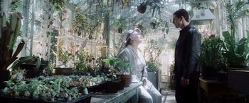 Movie still from “Minority Report” (2002), directed by Steven Spielberg – A woman sitting on top of a bench in a greenhouse; Medium shot, Over the shoulder angle