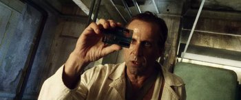 Movie still from “Minority Report” (2002), directed by Steven Spielberg – A man taking a picture of himself with a cell phone; Close Up shot, Over the shoulder angle