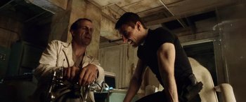 Movie still from “Minority Report” (2002), directed by Steven Spielberg – Two men talking to each other while sitting on a bike; Medium shot, Low angle