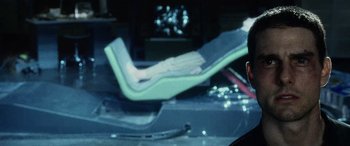 Movie still from “Minority Report” (2002), directed by Steven Spielberg – A person sitting on a chair in a room; Close Up shot, High angle