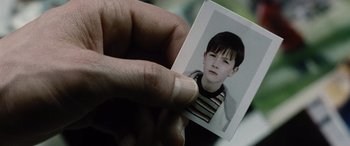 Movie still from “Minority Report” (2002), directed by Steven Spielberg – A person holding a picture of a young boy; Extreme Close Up shot, High angle