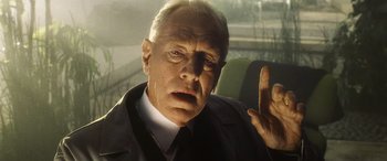 Movie still from “Minority Report” (2002), directed by Steven Spielberg – An older man in a suit and tie in a car; Close Up shot, Low angle