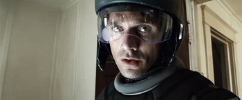 Movie still from “Minority Report” (2002), directed by Steven Spielberg – A person wearing a motorcycle helmet; Close Up shot, Over the shoulder angle