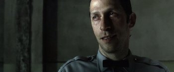 Movie still from “Minority Report” (2002), directed by Steven Spielberg – A person wearing a police uniform; Close Up shot, Low angle