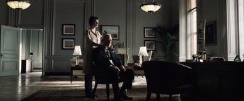 Movie still from “Minority Report” (2002), directed by Steven Spielberg – A man and a woman sitting in a chair in a living room; Medium shot, Low angle