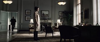 Movie still from “Minority Report” (2002), directed by Steven Spielberg – A woman standing in a living room in front of a fireplace; Wide shot, Low angle