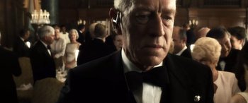 Movie still from “Minority Report” (2002), directed by Steven Spielberg – An older man in a tuxedo with a cell phone in his ear; Close Up shot, Low angle