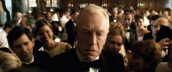 Movie still from “Minority Report” (2002), directed by Steven Spielberg – An older man in a tuxedo and a bow tie; Close Up shot, Low angle