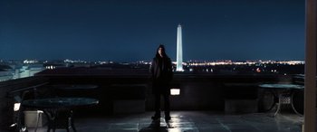 Movie still from “Minority Report” (2002), directed by Steven Spielberg – A man standing on a ledge in front of the washington monument at night; Wide shot, Low angle