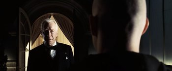 Movie still from “Minority Report” (2002), directed by Steven Spielberg – An older man in a tuxedo looking at himself in a mirror; Close Up shot, Over the shoulder angle
