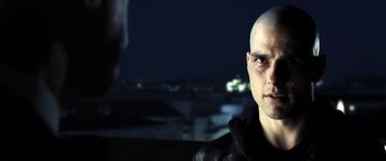 Movie still from “Minority Report” (2002), directed by Steven Spielberg – A man with a bald head is looking at the camera; Close Up shot, Over the shoulder angle