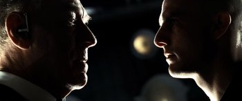 Movie still from “Minority Report” (2002), directed by Steven Spielberg – Two people face to face in a dark room; Close Up shot, Over the shoulder angle