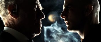 Movie still from “Minority Report” (2002), directed by Steven Spielberg – Two men face to face with smoke coming out of their mouths; Close Up shot, Over the shoulder angle
