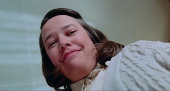 Movie still from “Misery” (1990), directed by Rob Reiner – A person with long brown hair; Close Up shot, Low angle