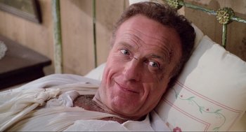 Movie still from “Misery” (1990), directed by Rob Reiner – A person laying in a hospital bed; Close Up shot, High angle