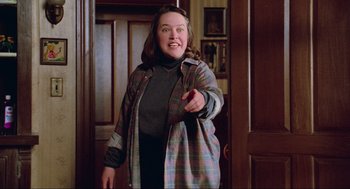 Movie still from “Misery” (1990), directed by Rob Reiner – A woman in a plaid jacket pointing at the camera; Medium shot, Over the shoulder angle