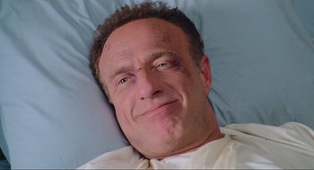 Movie still from “Misery” (1990), directed by Rob Reiner – A person laying in a hospital bed; Close Up shot, Overhead angle