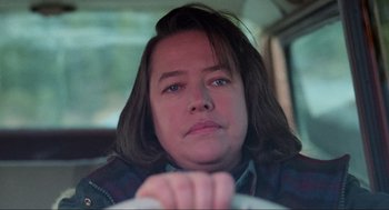 Movie still from “Misery” (1990), directed by Rob Reiner – A woman sitting in the driver's seat of a car; Close Up shot, Low angle
