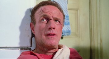 Movie still from “Misery” (1990), directed by Rob Reiner – A person wearing a red t - shirt; Close Up shot, Low angle