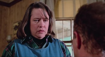 Movie still from “Misery” (1990), directed by Rob Reiner – A woman in a plaid shirt is looking at a man in a plaid shirt; Close Up shot, Over the shoulder angle