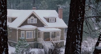 Movie still from “Misery” (1990), directed by Rob Reiner – A house in the woods covered in snow; Extreme Wide shot, High angle