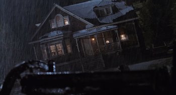 Movie still from “Misery” (1990), directed by Rob Reiner – A house that has a lot of lights in it; Extreme Wide shot, Low angle