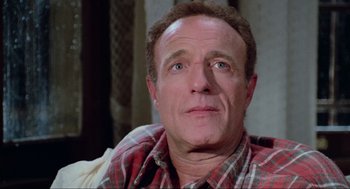 Movie still from “Misery” (1990), directed by Rob Reiner – A person sitting on a couch; Close Up shot, Low angle