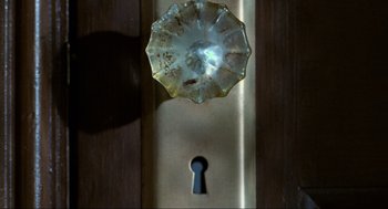 Movie still from “Misery” (1990), directed by Rob Reiner – A door knob and a keyhole; Extreme Close Up shot, Overhead angle