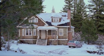 Movie still from “Misery” (1990), directed by Rob Reiner – An old house in the middle of the snow; Extreme Wide shot, Low angle