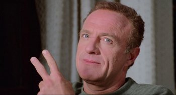 Movie still from “Misery” (1990), directed by Rob Reiner – A person holding a finger up; Close Up shot, Low angle