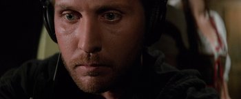 Movie still from “Mission: Impossible” (1996), directed by Brian De Palma – A person wearing headphones; Close Up shot, High angle